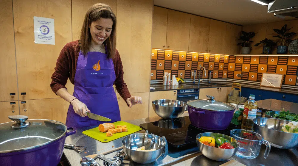 IMD Ambassador Lara cooking at Migrateful