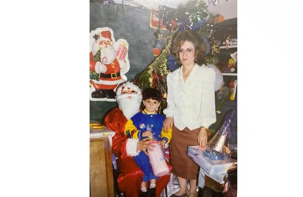 parents by christmas tree with Santa