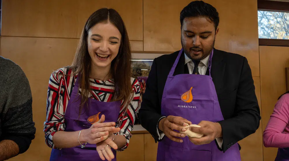 IMD Ambassadors Veronica and Nivek cooking at Migrateful